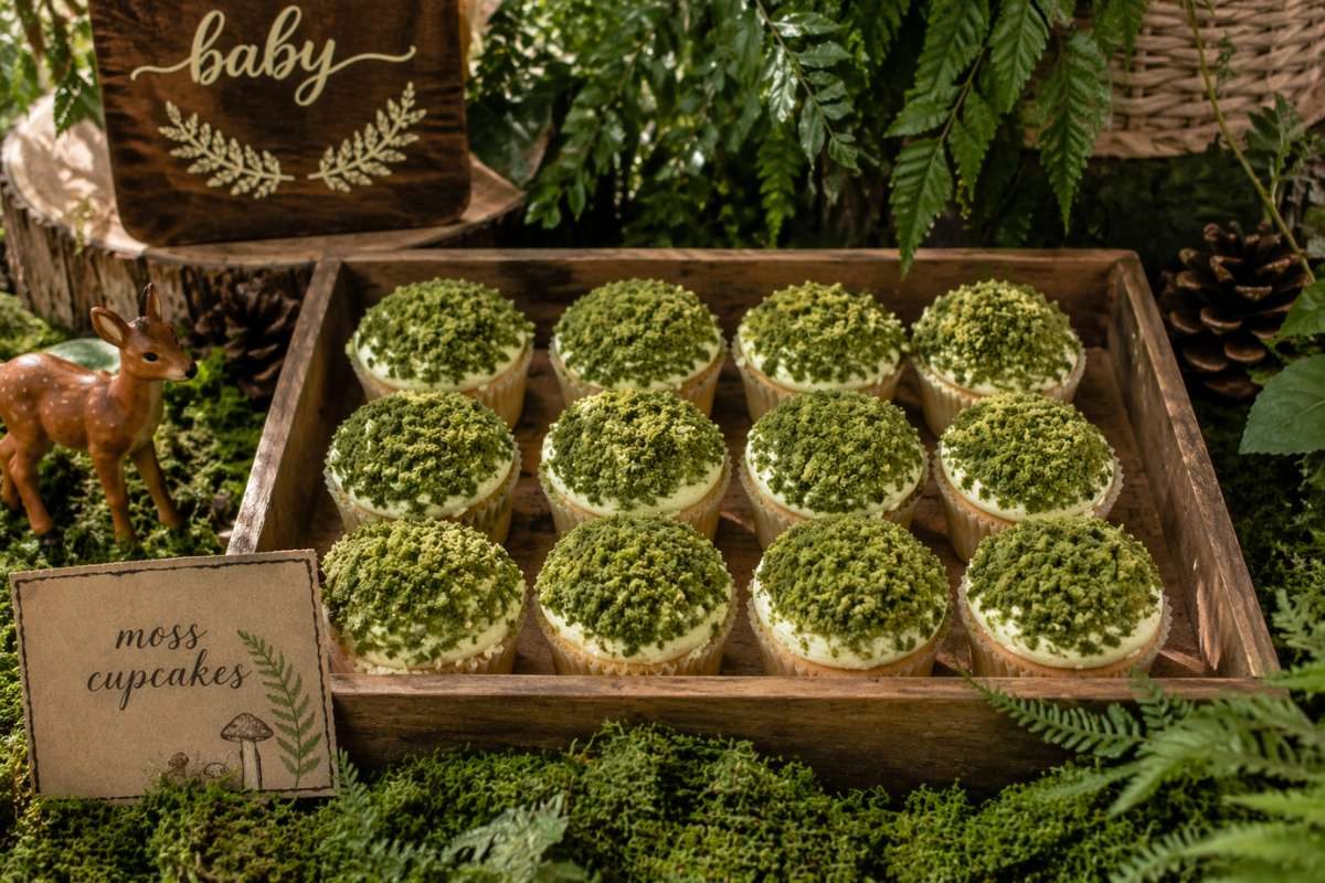 Green moss cupcakes with crushed cookies for a woodland baby shower dessert table