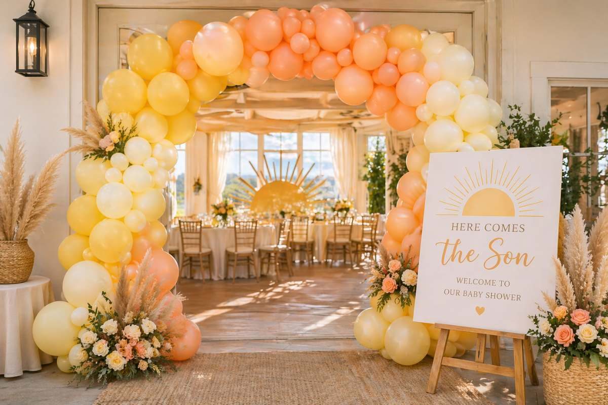 Sunrise balloon arch entrance with yellow, peach, and cream balloons for Here Comes the Son baby shower