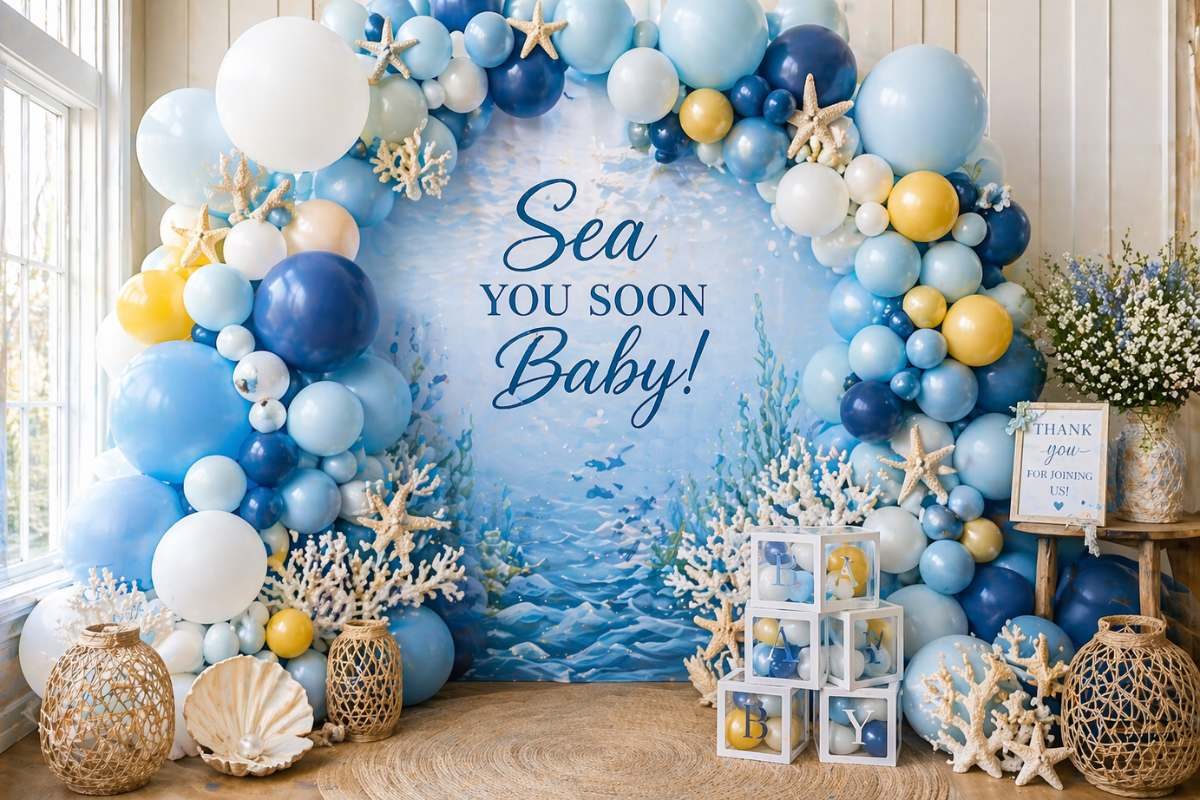 Underwater balloon arch backdrop in blue and white for Sea You Soon baby shower photos.